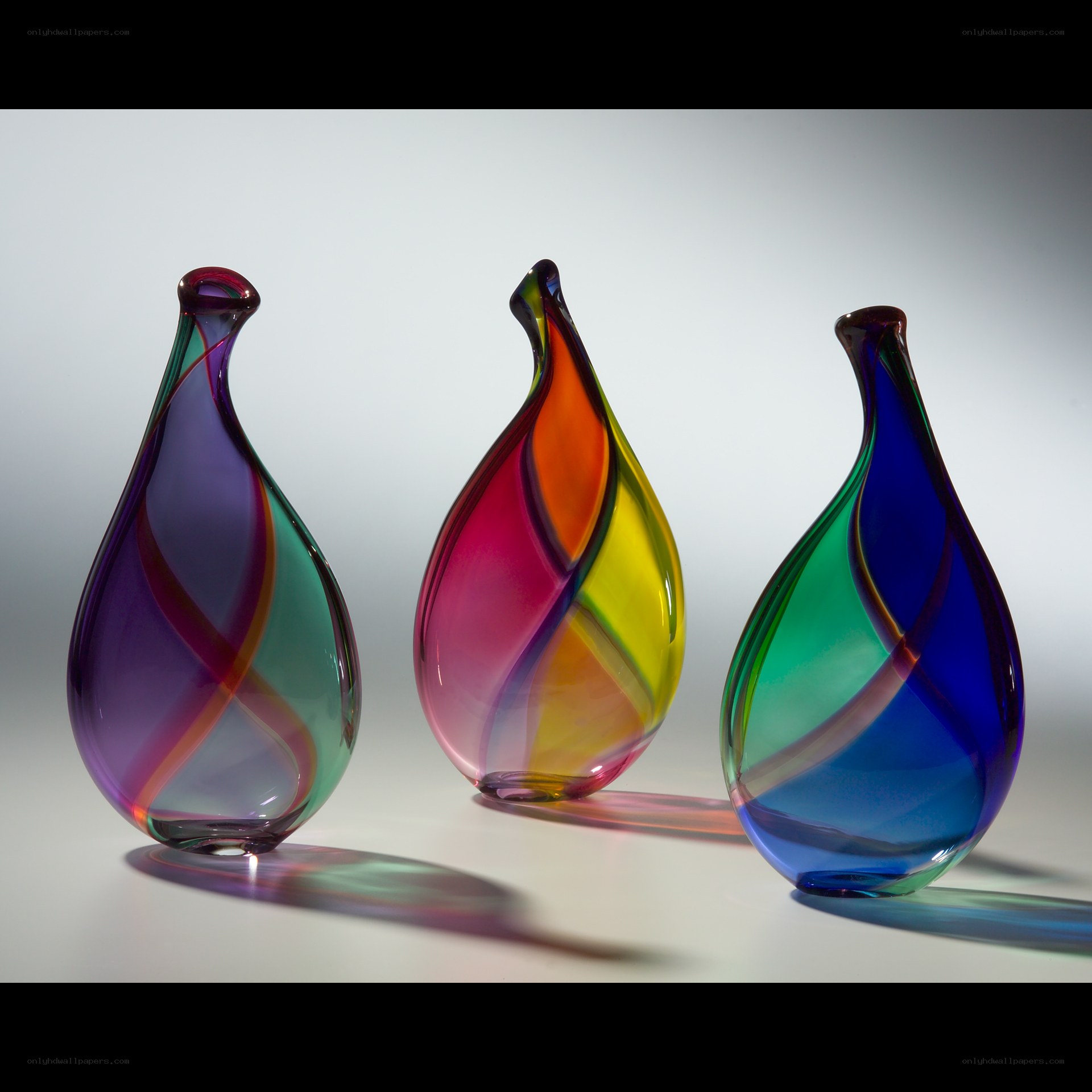 Three colorful glass vases