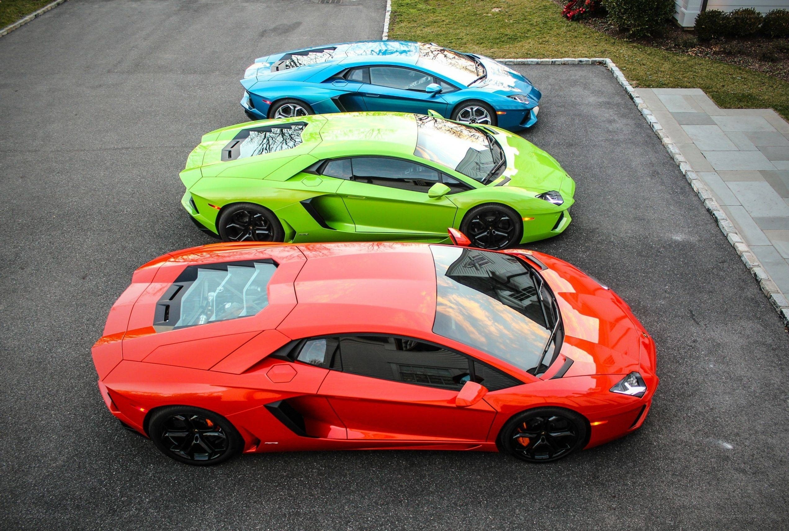 Three colorful Lamborghini Aventadors