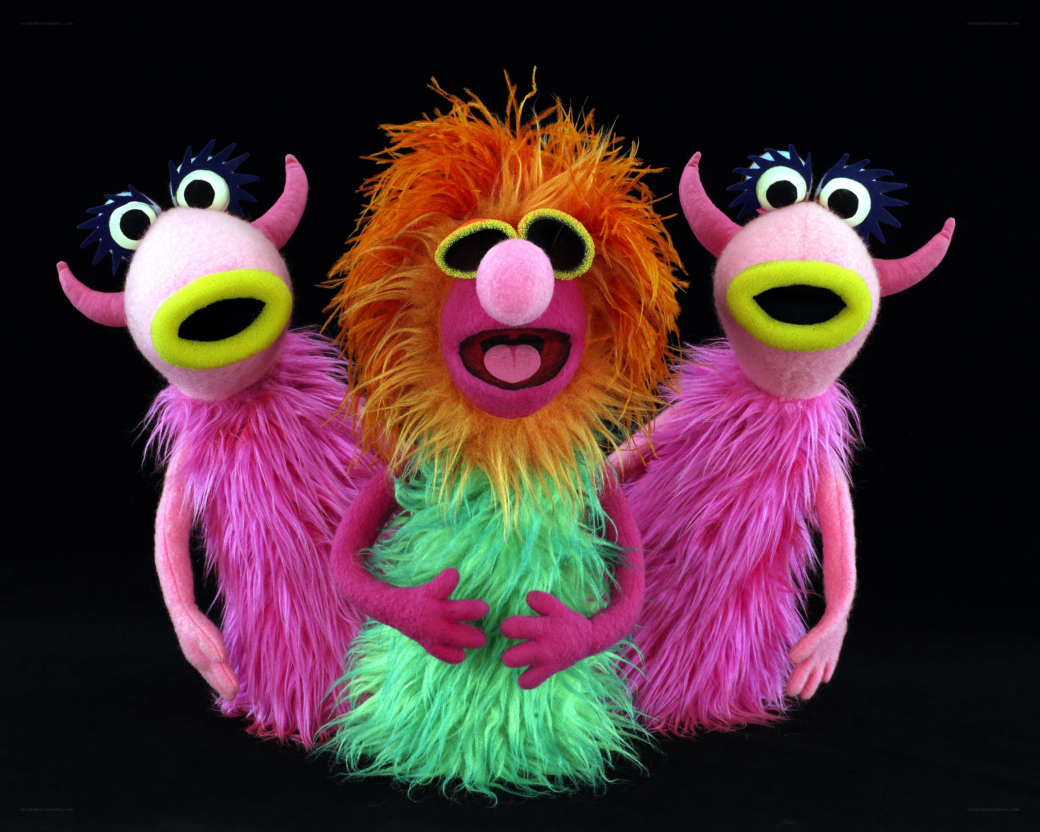 Three colorful puppet monsters