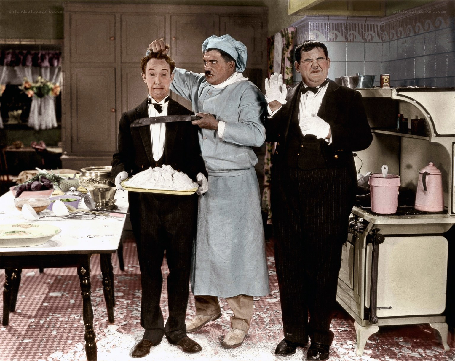 Three comedians in a kitchen