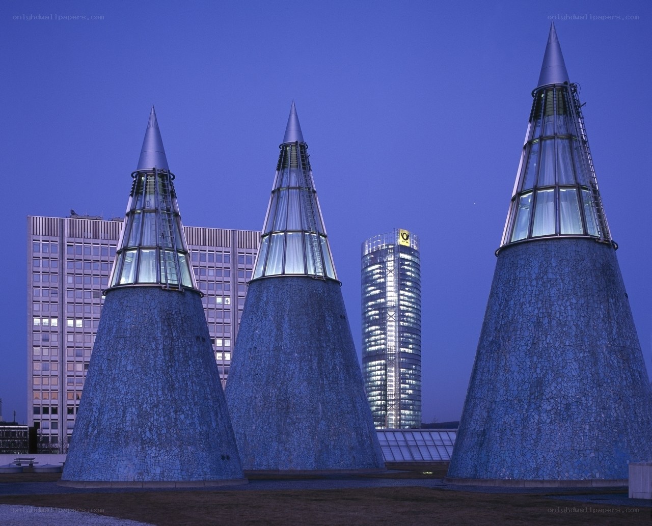 Three cone-shaped towers at dusk