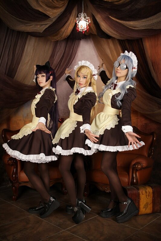 three cosplayers in maid outfits