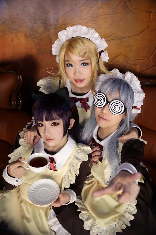 Three cosplayers in maid outfits