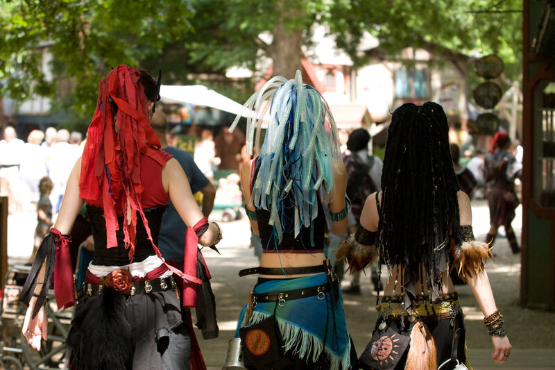 Three costumed attendees at a festival