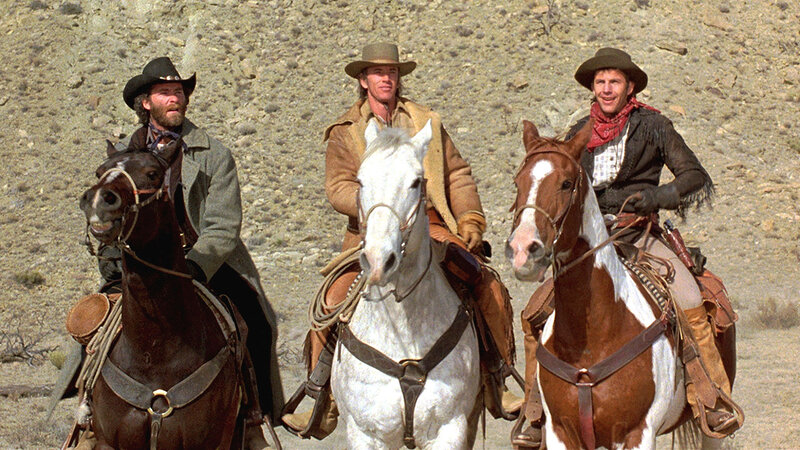 three cowboys on horseback