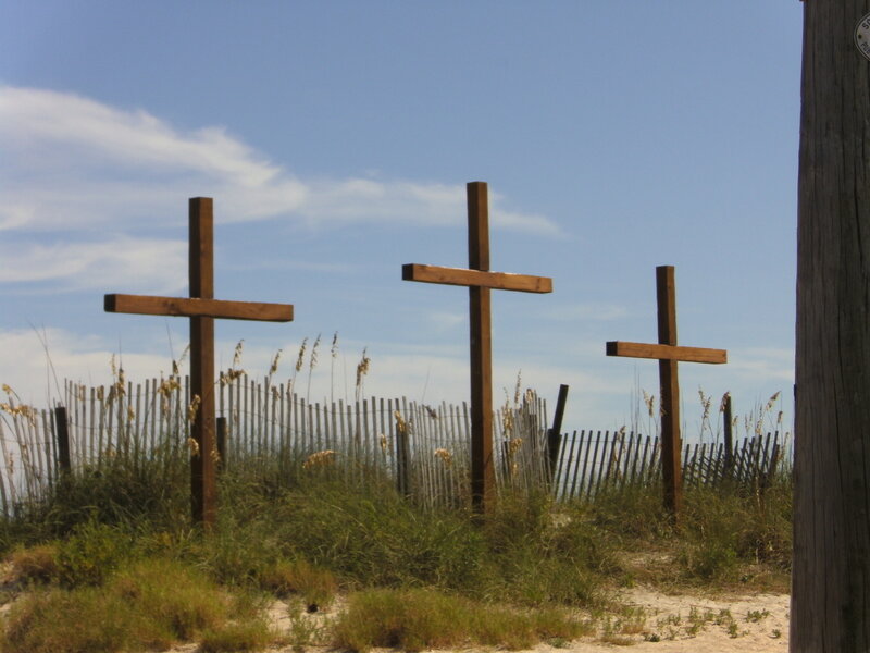 Three crosses on a beach