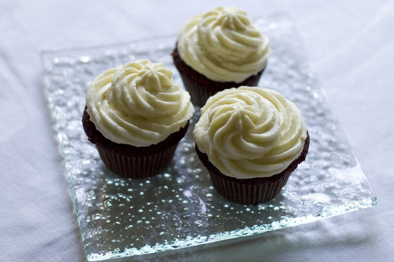 Three cupcakes on a glass plate