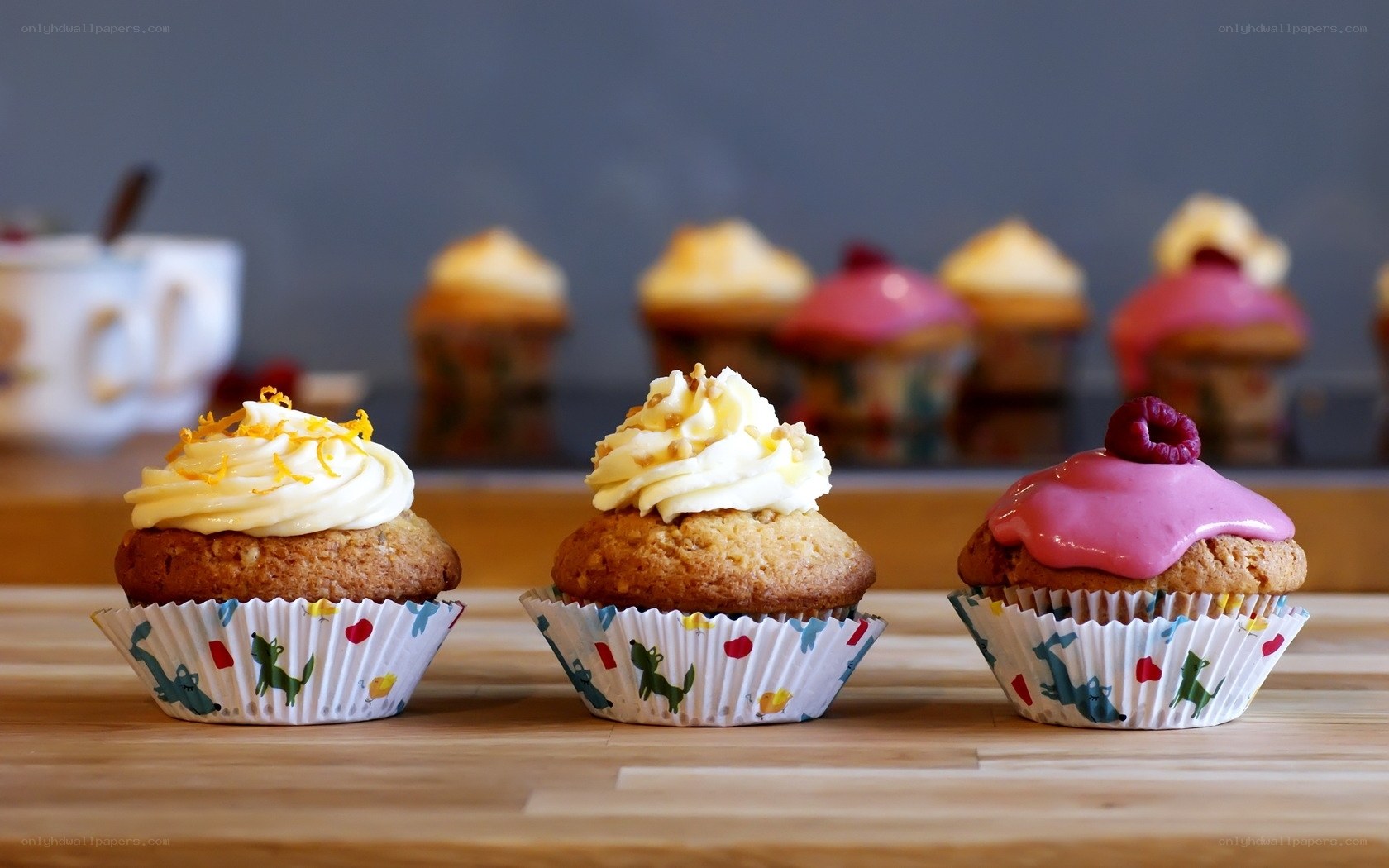 Three cupcakes on a wooden table