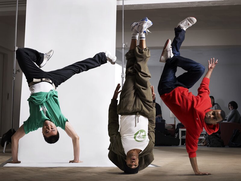 Three dancers in handstands