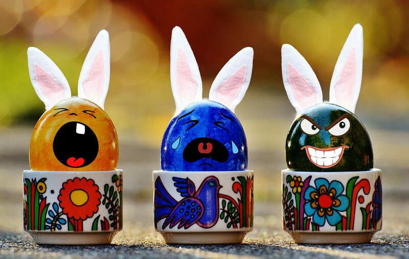 Three decorated Easter eggs with bunny ears