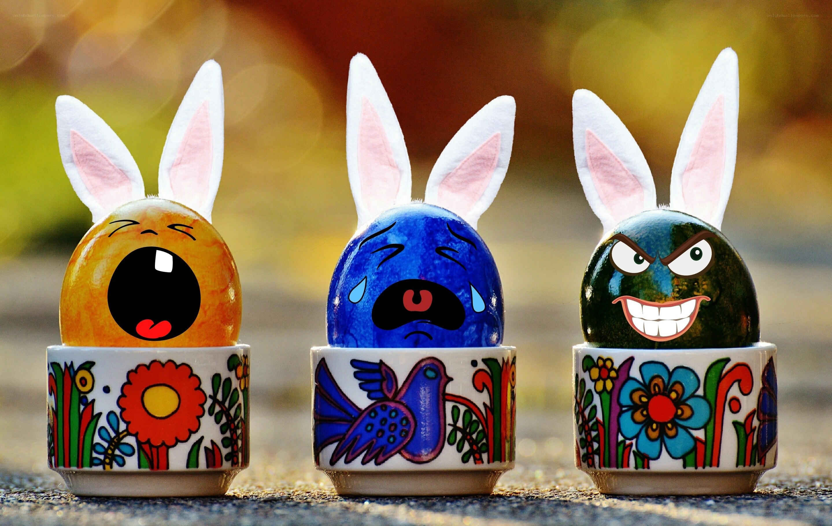 Three decorated Easter eggs with bunny ears