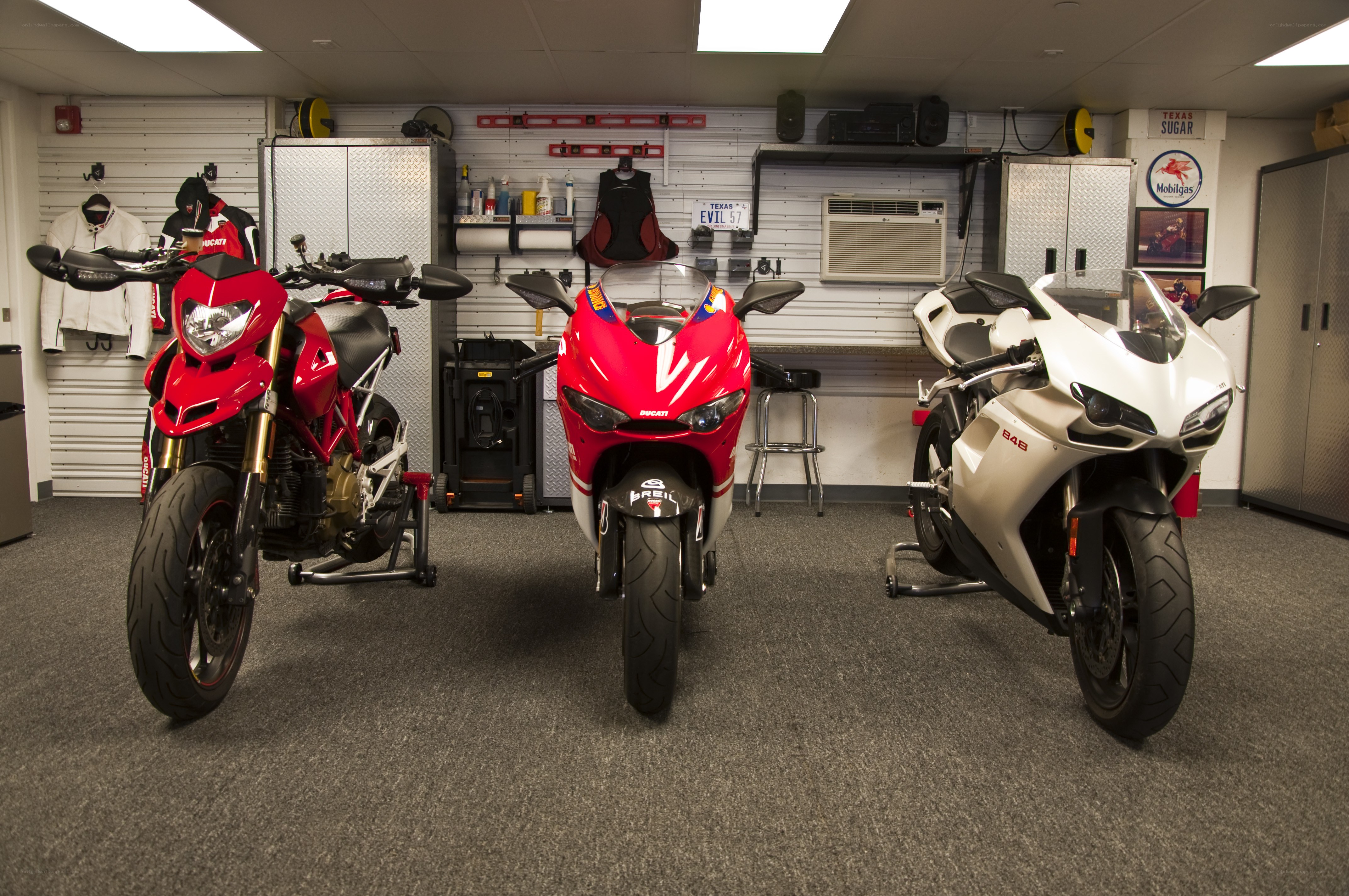 Three Ducati motorcycles in garage