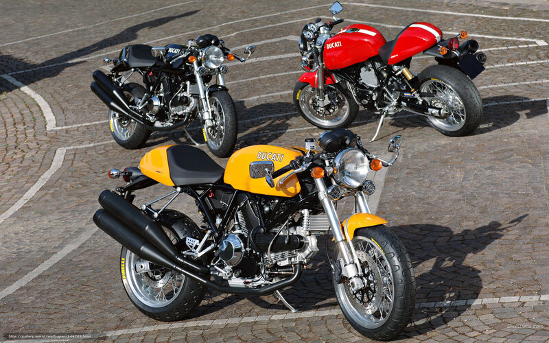 Three Ducati motorcycles on pavement