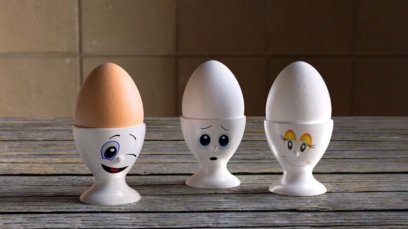 Three egg cups with faces