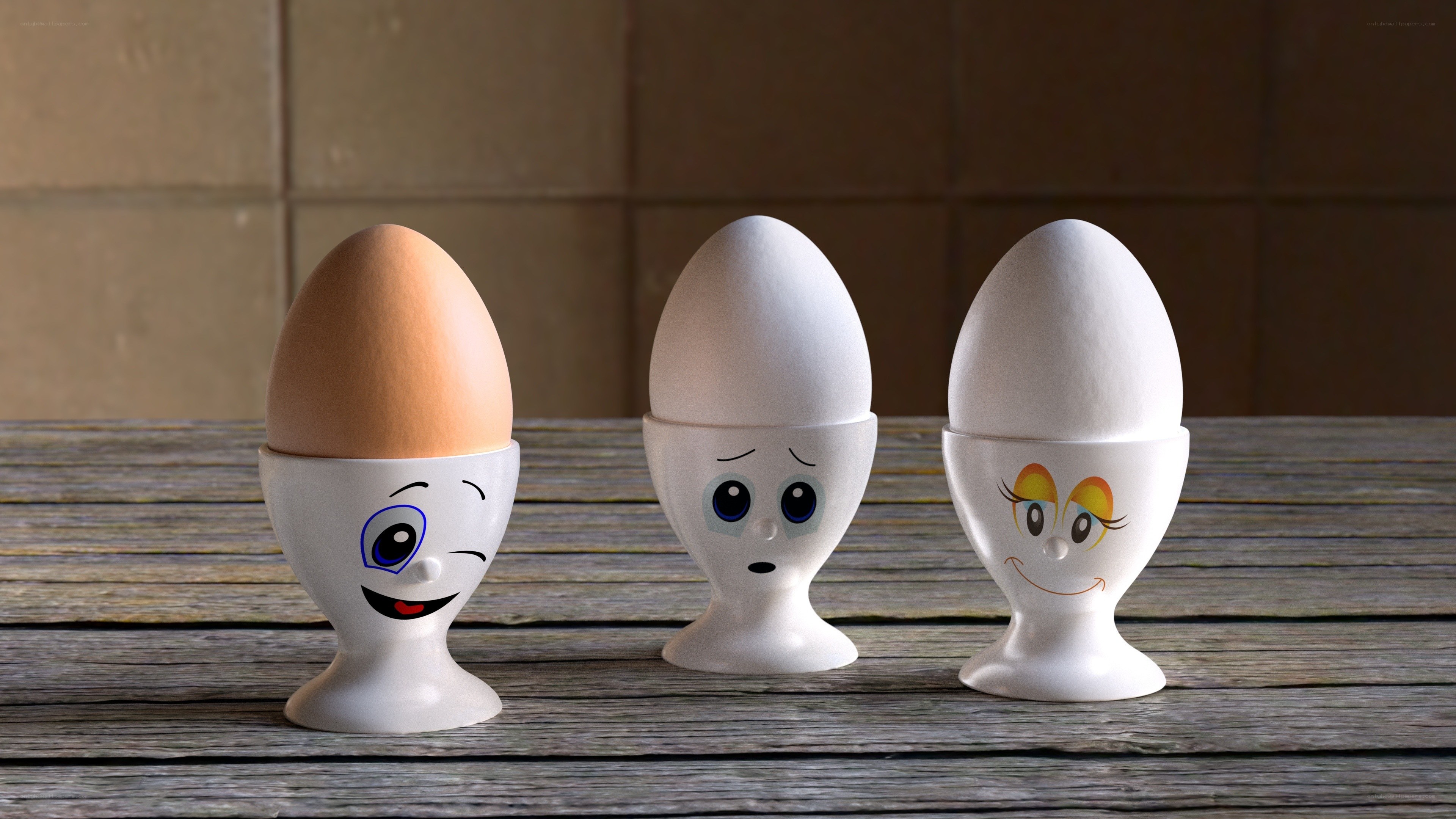 Three egg cups with faces