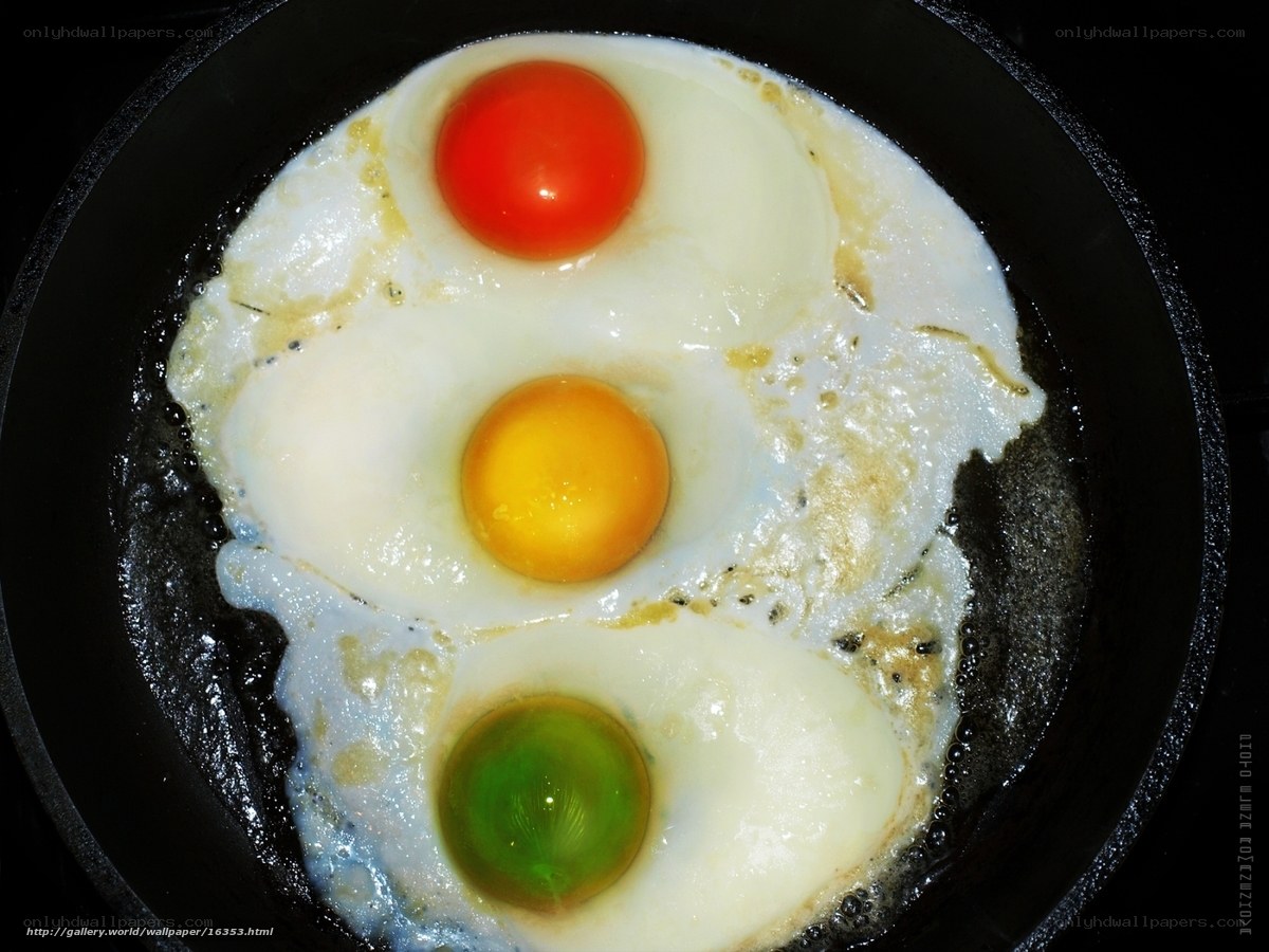 Three eggs frying in a pan