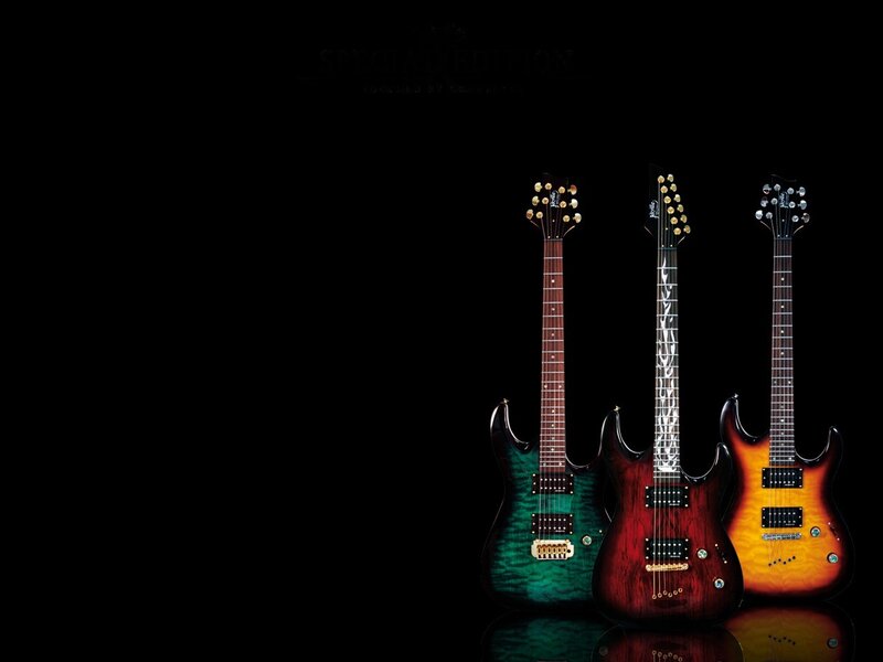 three electric guitars on black