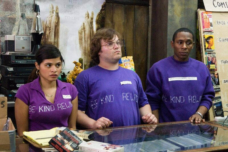 Three employees in purple shirts