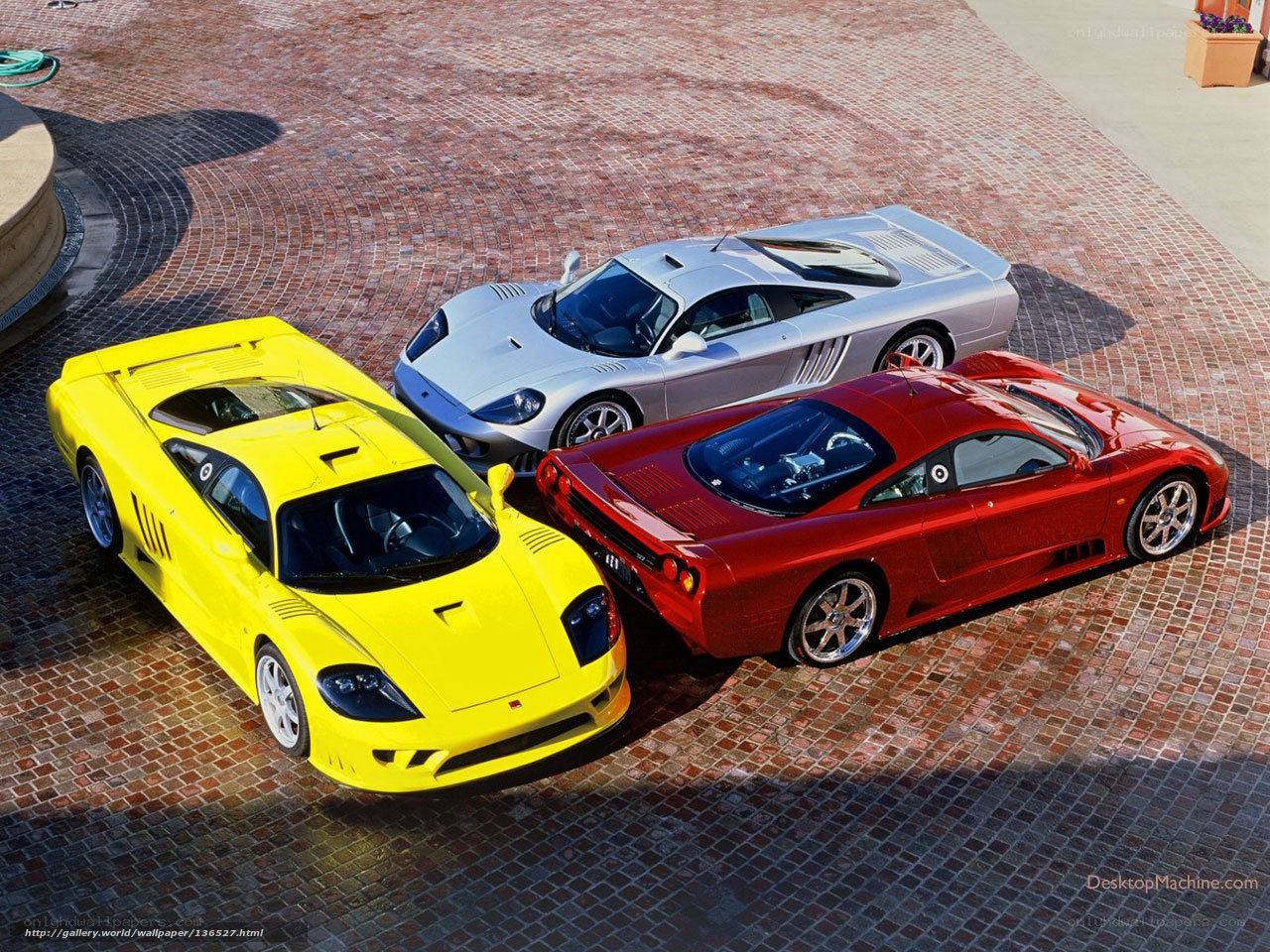 Three exotic sports cars on brick