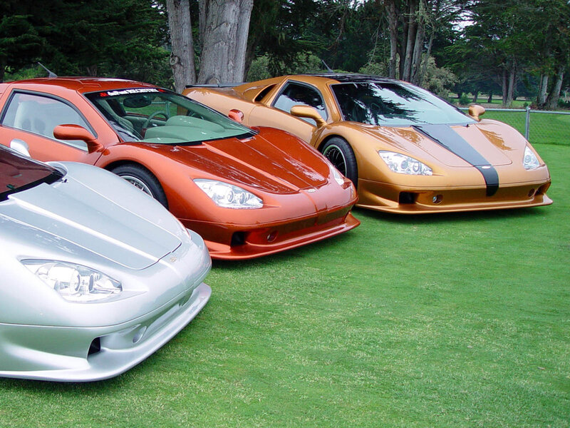 Three exotic sports cars on grass