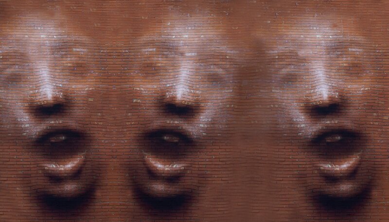 Three Faces on Brick Wall