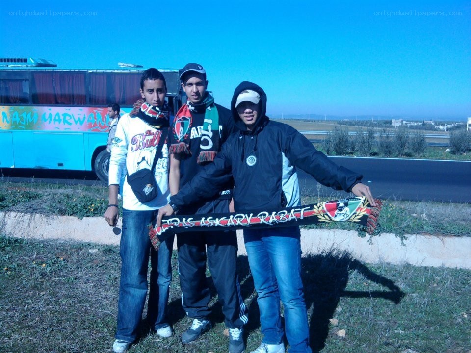 Three fans with team scarf