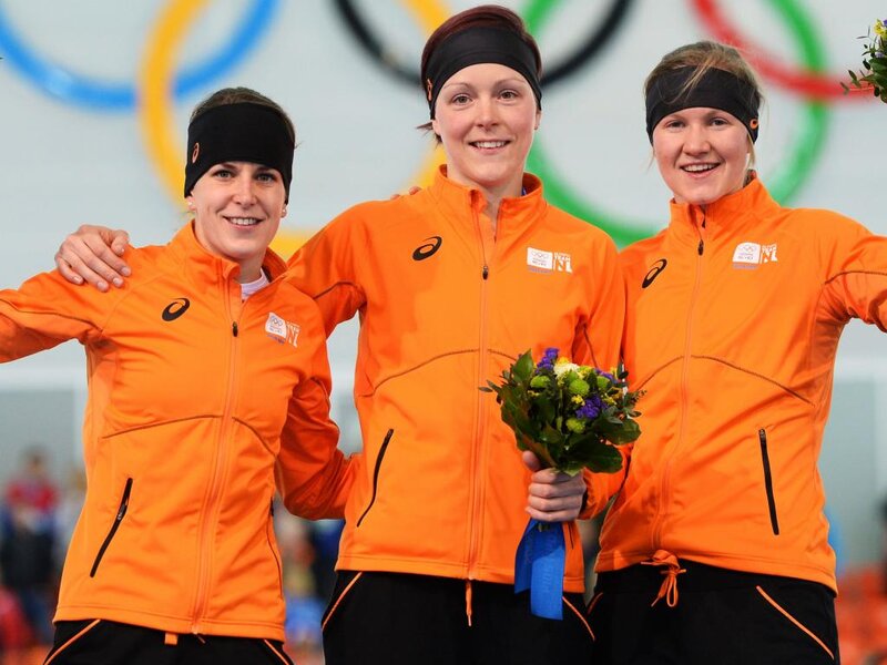 Three Female Athletes — Orange, Celebratory