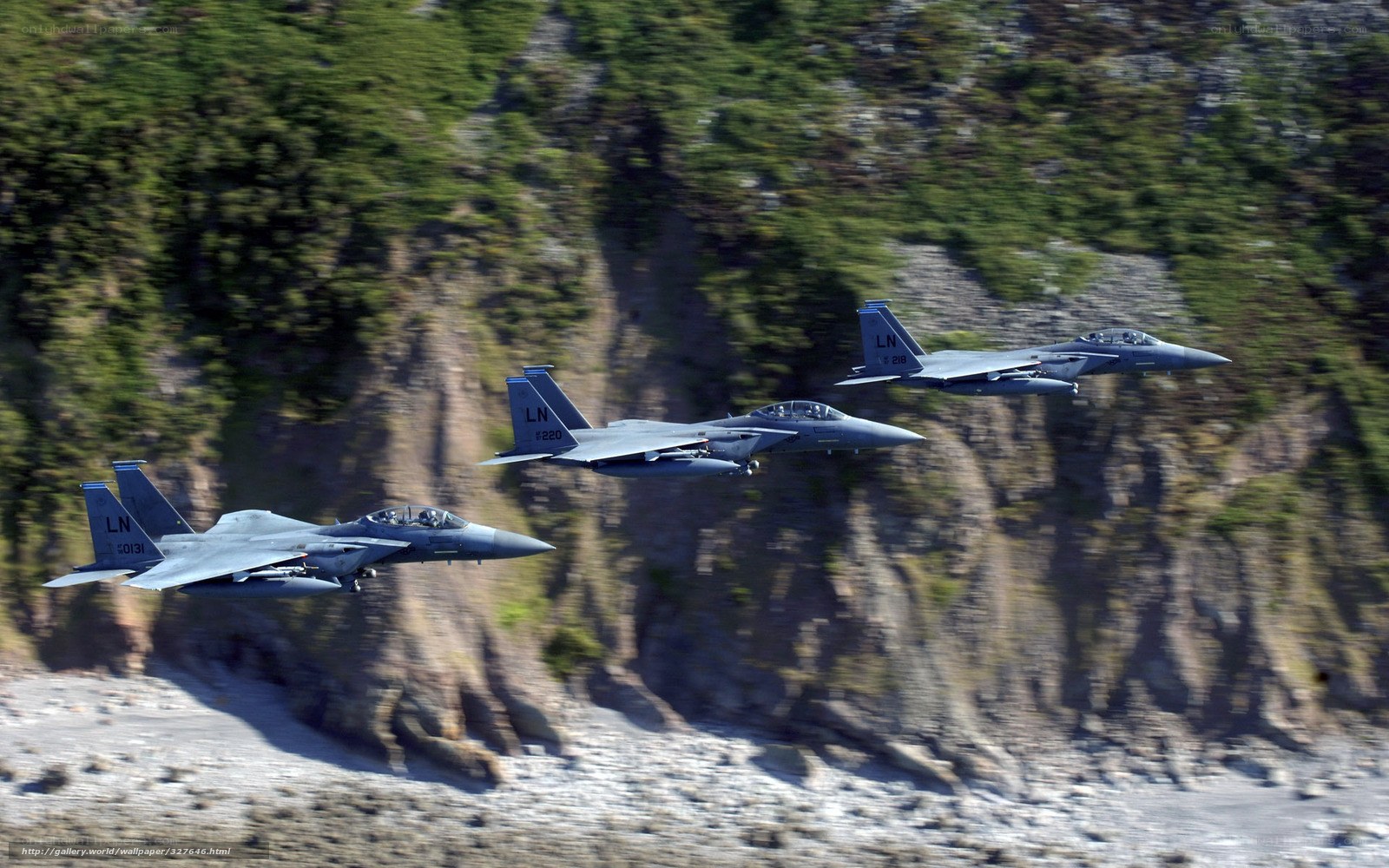 Three fighter jets in formation