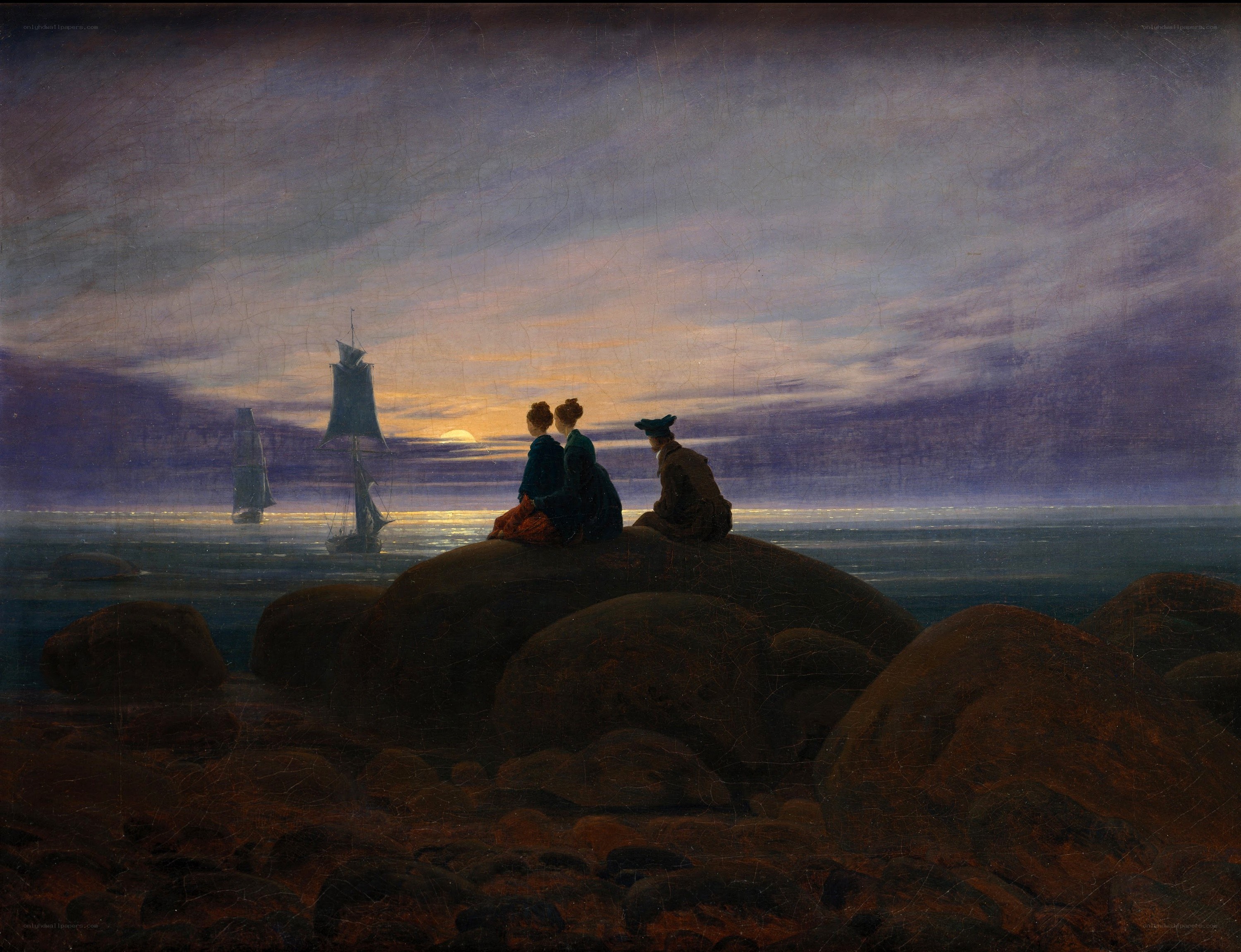 Three figures on a rocky shore