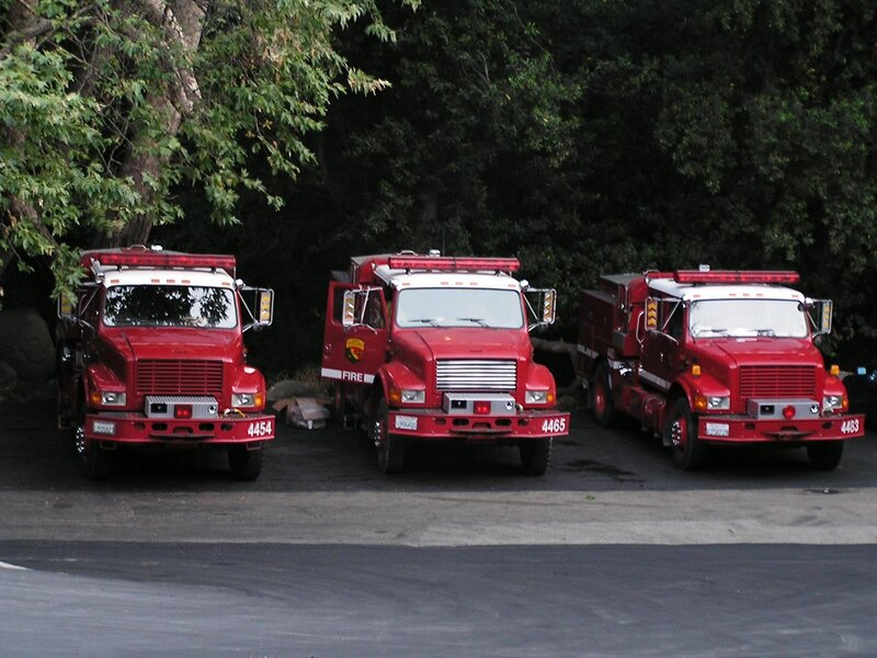 Three fire trucks parked in a row