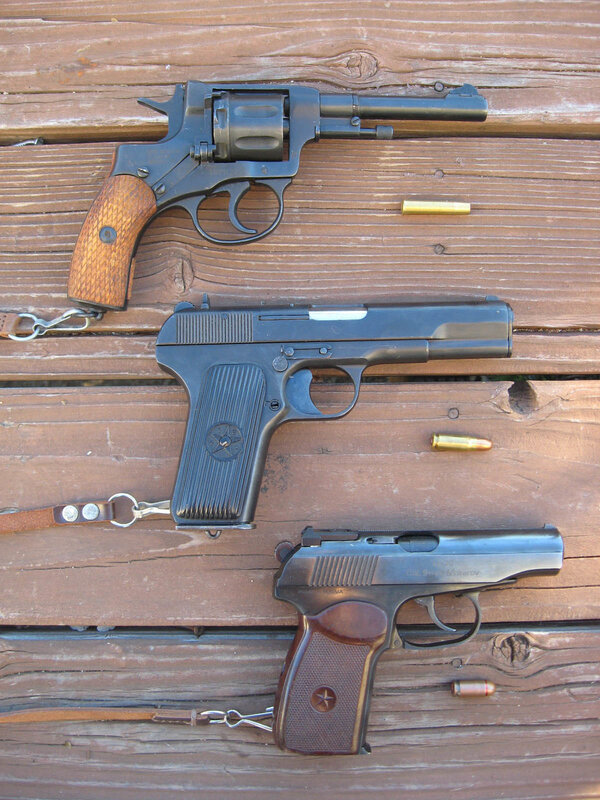 Three firearms on wood