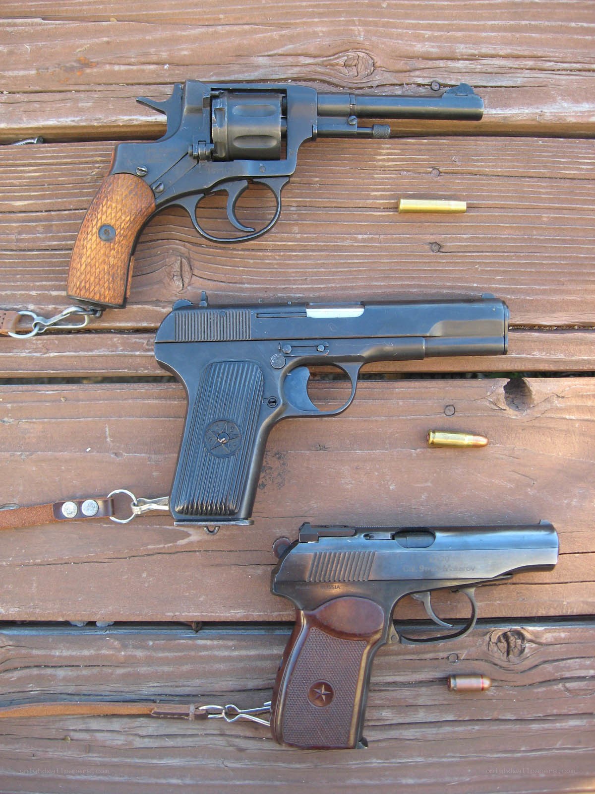 Three firearms on wood