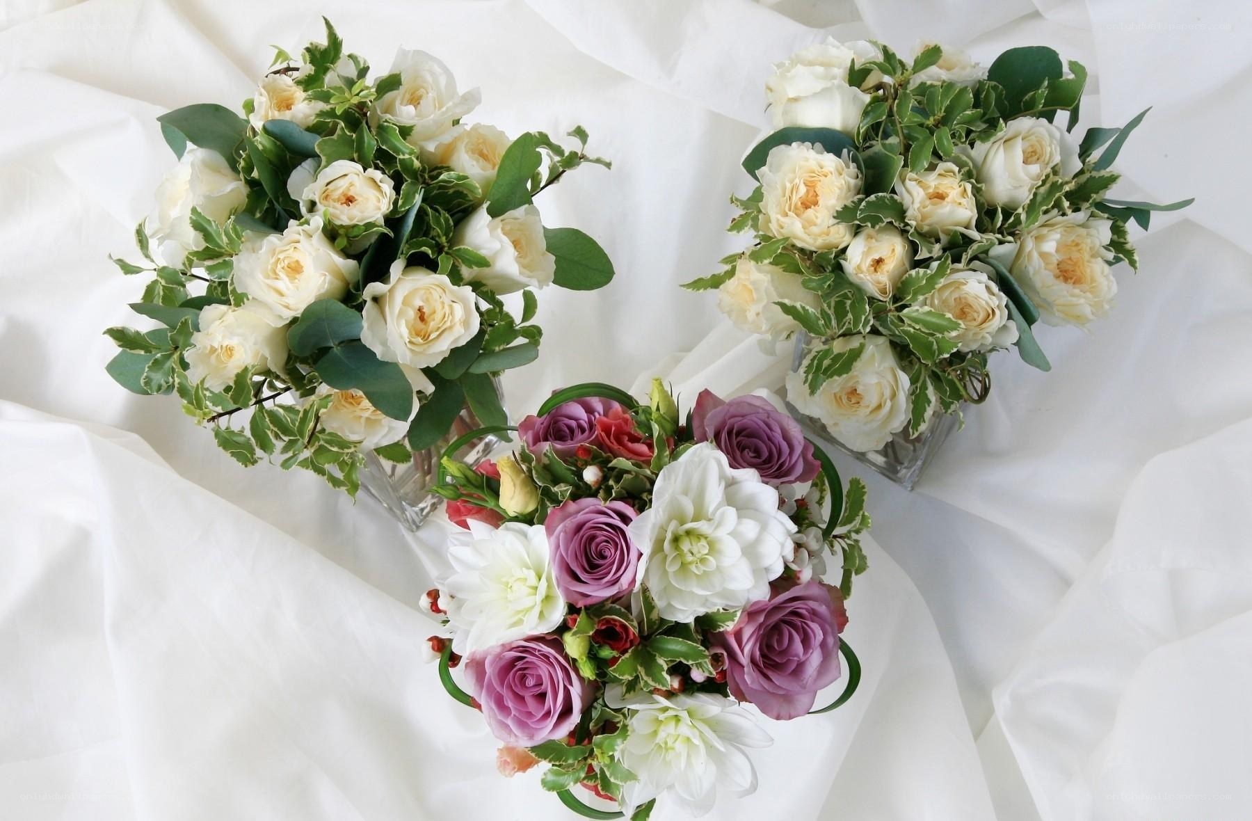 Three floral arrangements on white