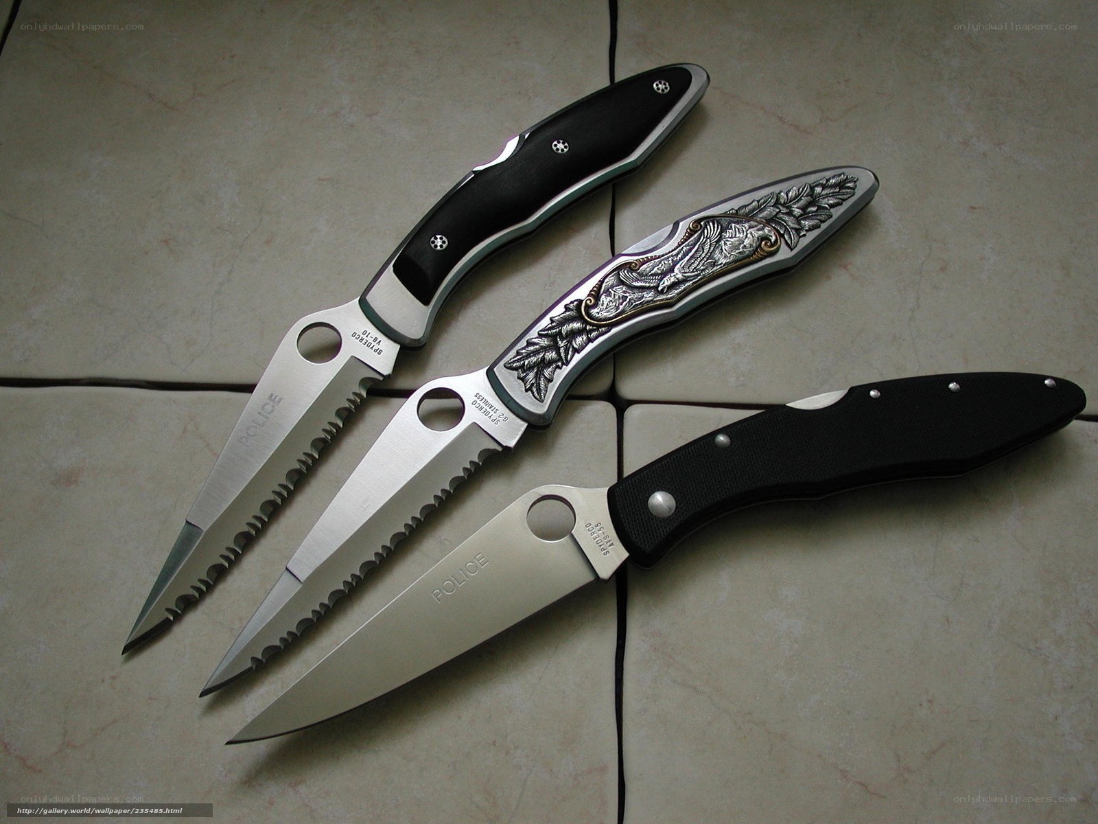 three folding knives on tile