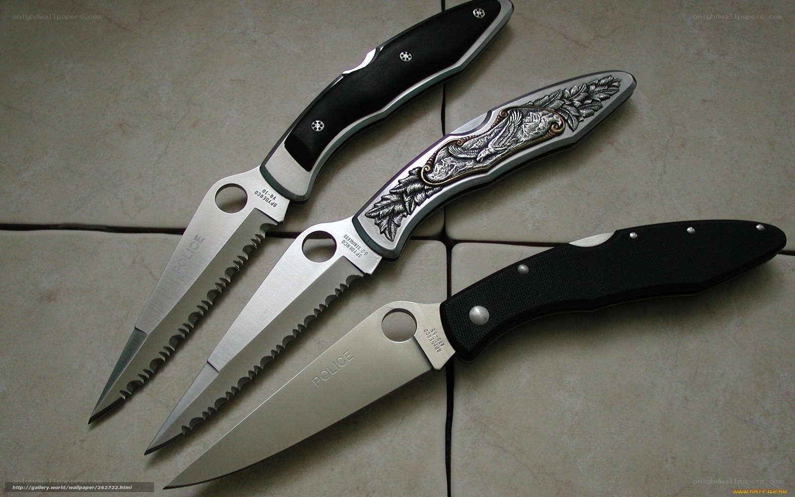 three folding knives on tile
