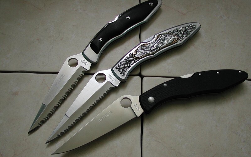Three folding knives on tile
