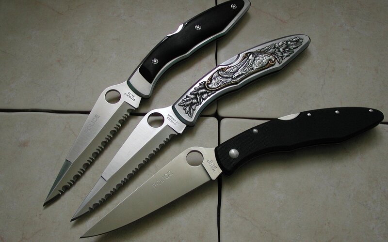 Three folding knives on tile