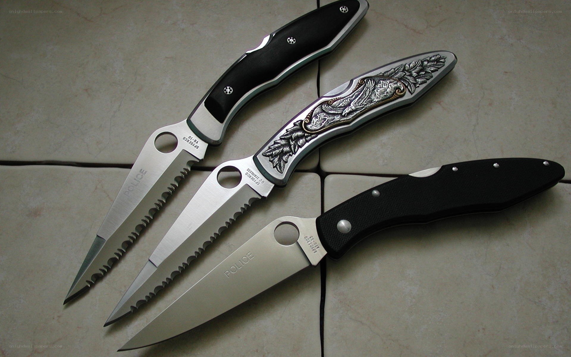 Three folding knives on tile