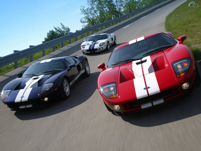 Three Ford GT sports cars on a road