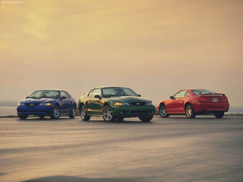 Three Ford Mustangs at sunset