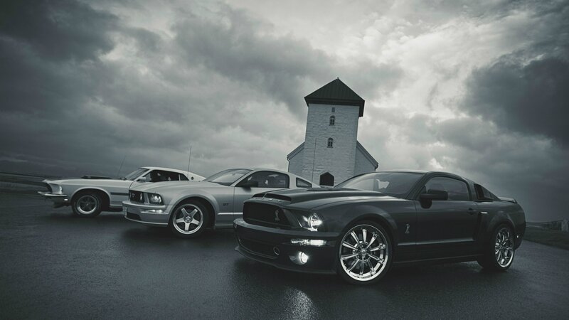 Three Ford Mustangs in front of a church
