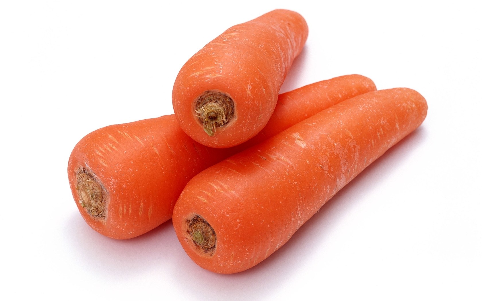Three fresh carrots on white
