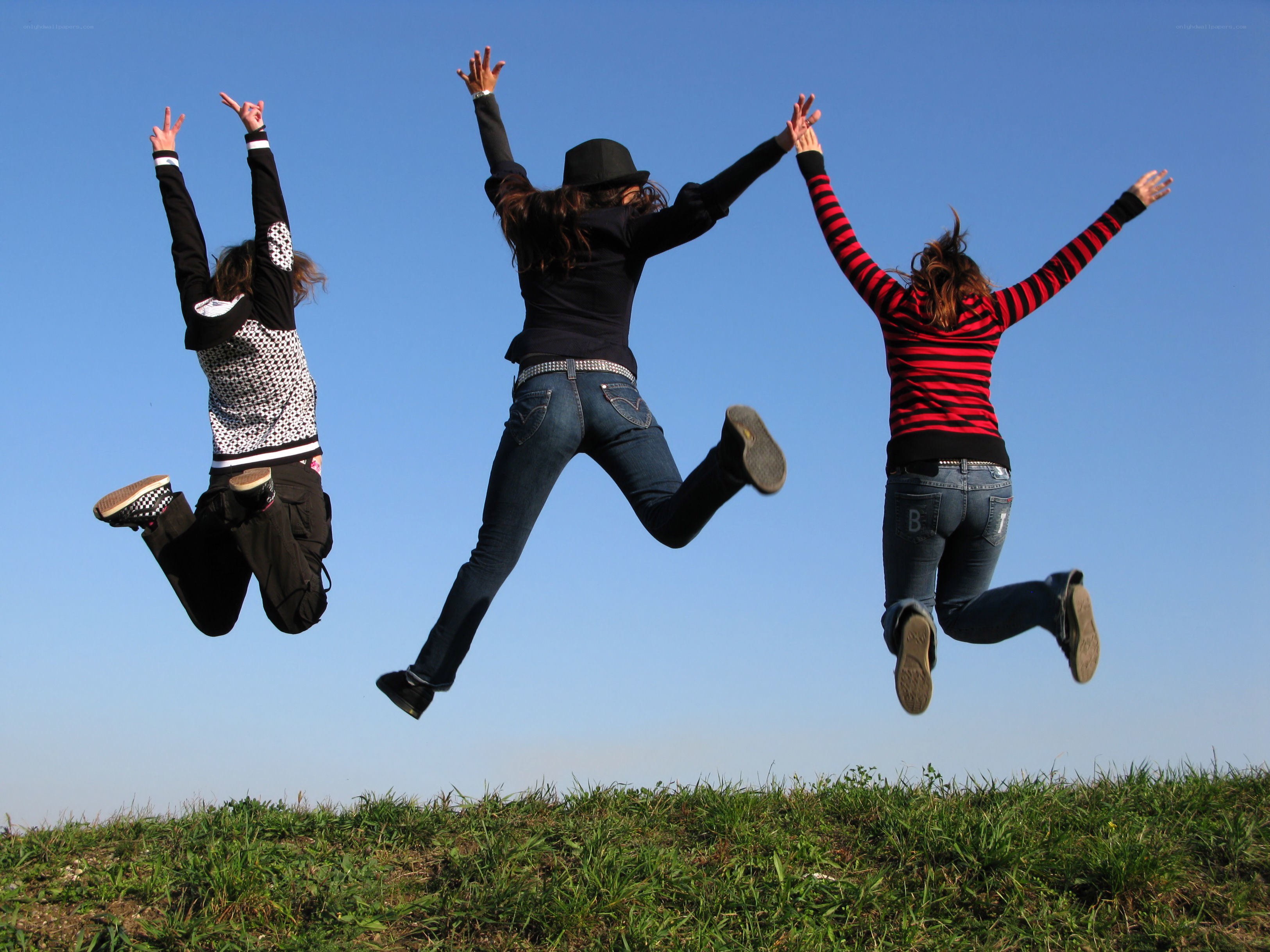 three friends jumping in the air