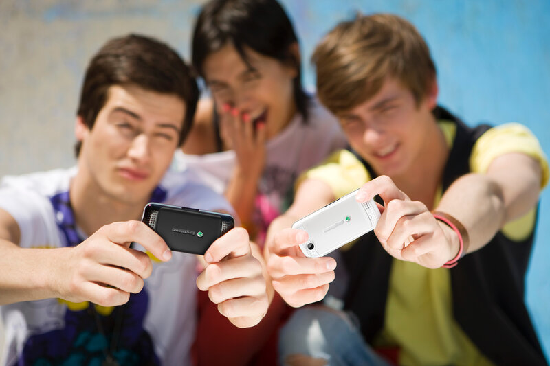 three friends using phones