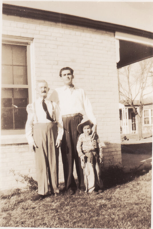 Three generations outside brick house