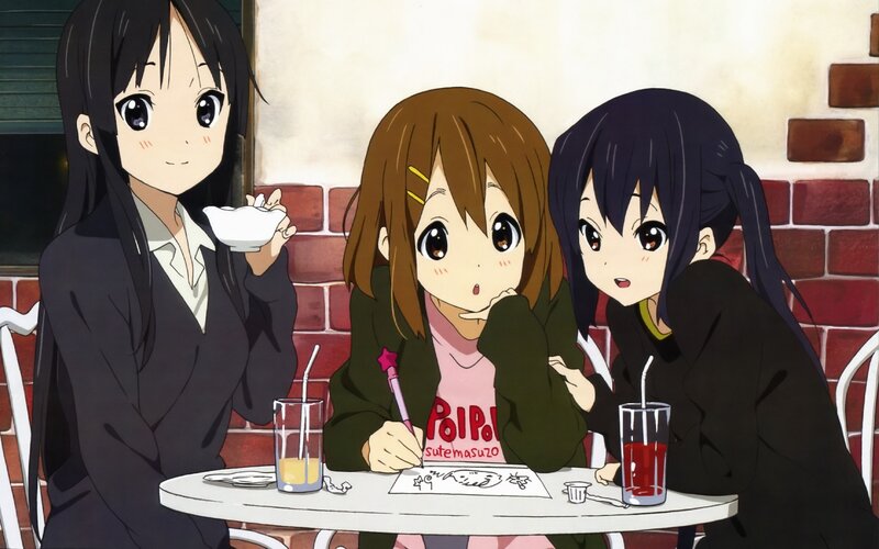 Three girls at a cafe table