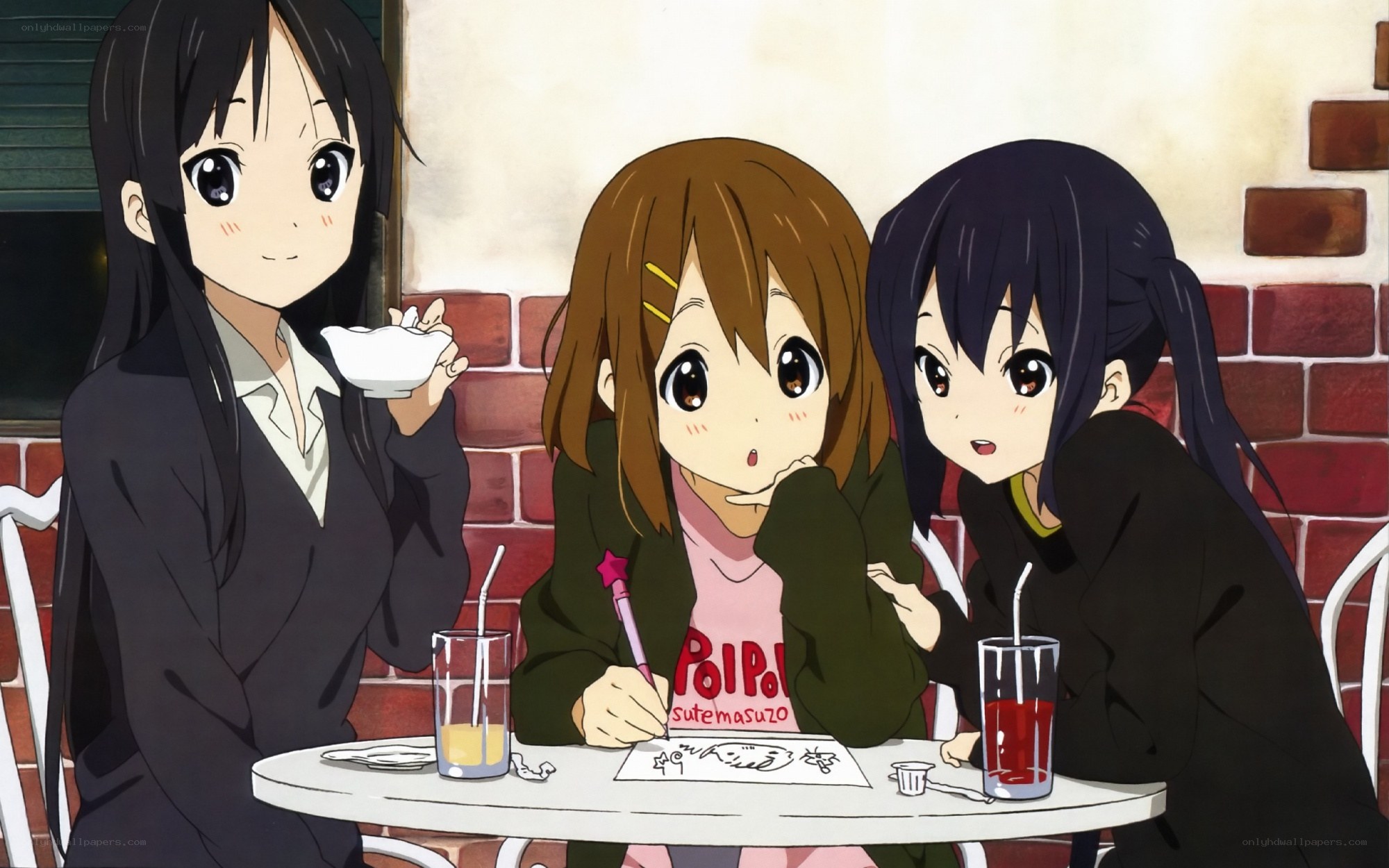 Three girls at a cafe table