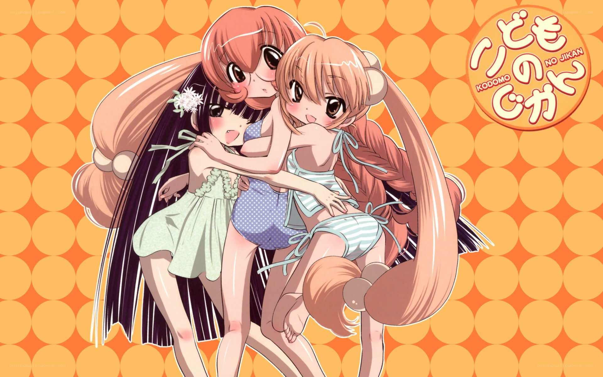 Three girls hugging in swimsuits