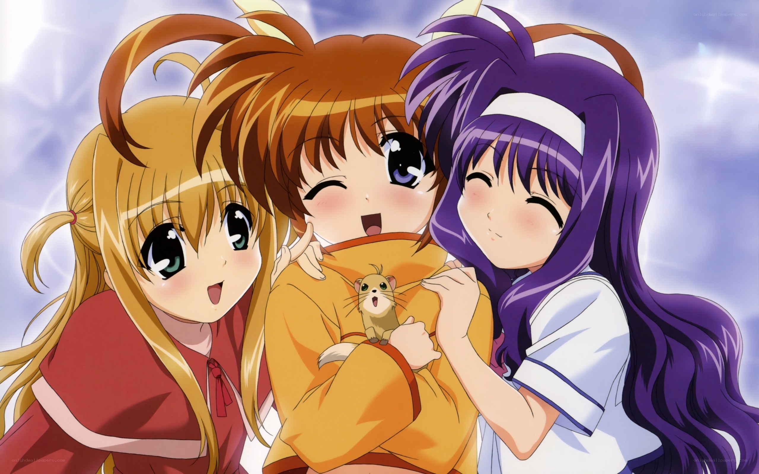 three girls hugging with a hamster