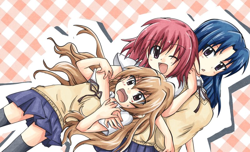 Three girls in a playful pile-up